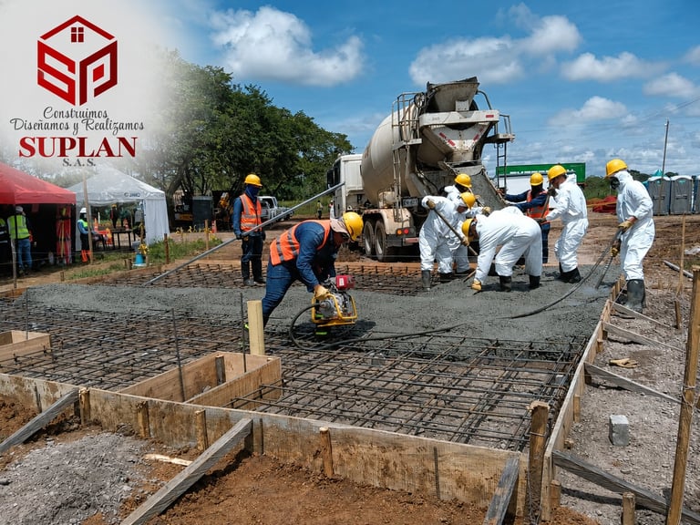 Construction workers pouring concrete on a building foundation with a cement mixer truck and reinforced steel rebar framework